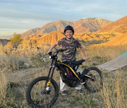 Person with a Natkie N1 Electric Dirt Bikee in a desert landscape
