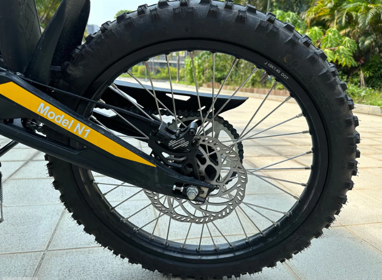 Close-up of Natkie N1 Electric Dirt Bike wheel with a yellow stripe